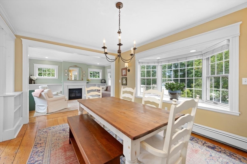 13 Ship Street Hingham, MA 02043 - Photo 11 of 37 a dining room with wooden floor a chandelier a wooden table and chairs