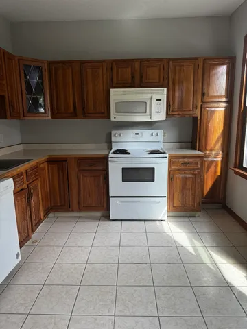 a kitchen with a stove top oven sink and cabinets