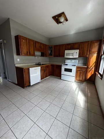 a kitchen with stainless steel appliances a stove a sink cabinets and a counter top space
