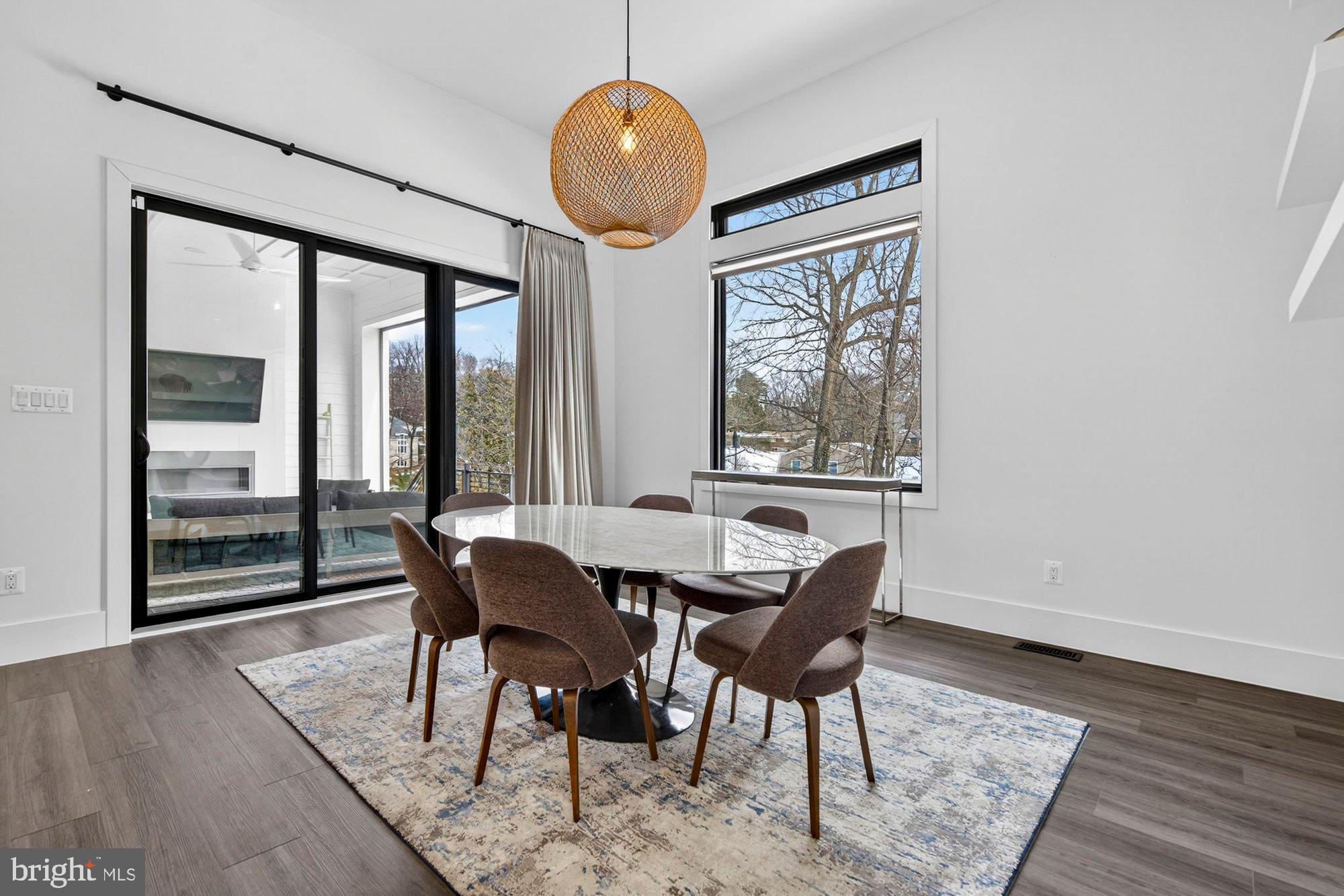 1221 Riley Preserve Court McLean, VA 22102 - Photo 16 of 94 a dining room with wooden floor glass table and chairs