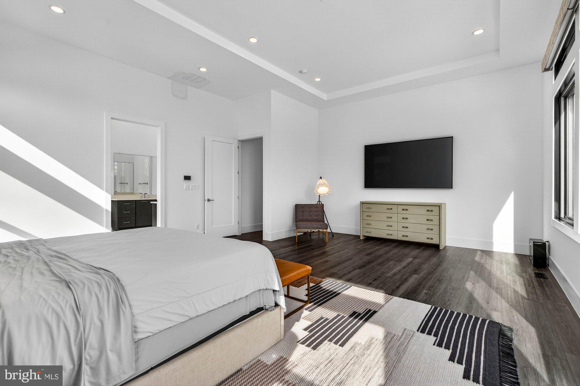 1221 Riley Preserve Court McLean, VA 22102 - Photo 26 of 94 a spacious bedroom with a bed and a flat screen television