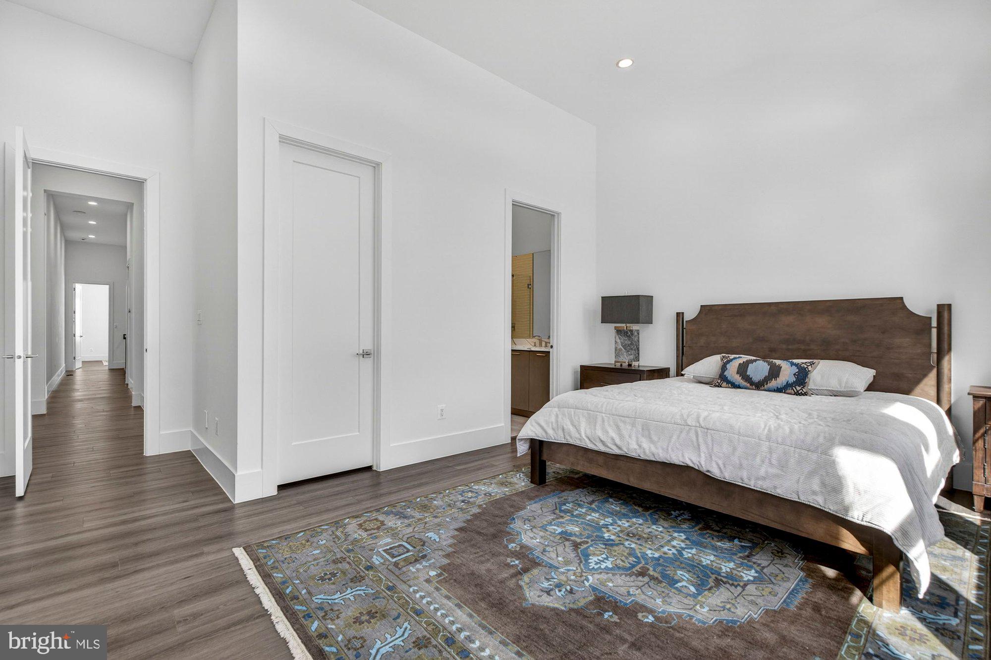 1221 Riley Preserve Court McLean, VA 22102 - Photo 40 of 94 a spacious bedroom with a bed and wooden floor