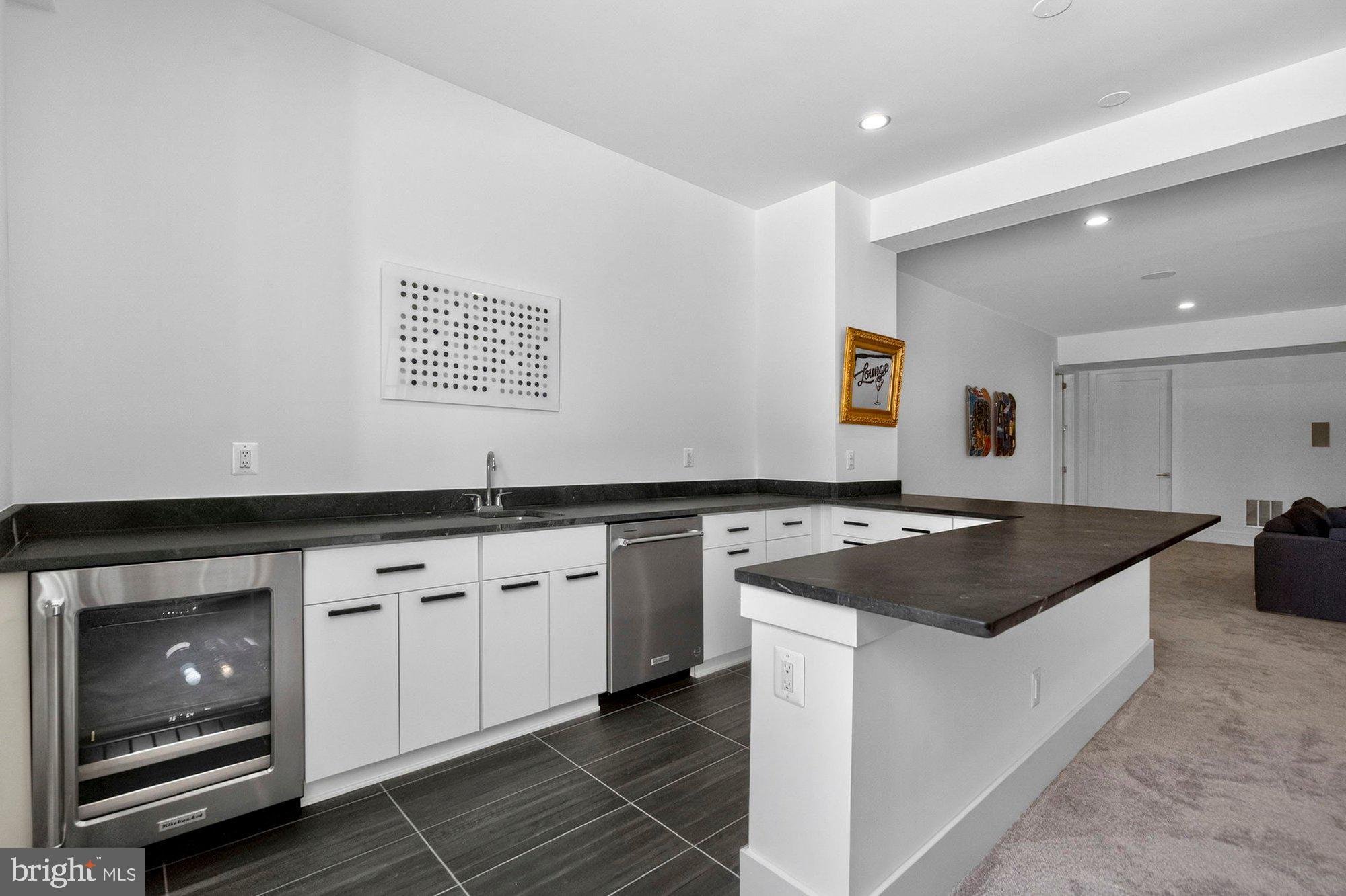 1221 Riley Preserve Court McLean, VA 22102 - Photo 64 of 94 a kitchen with granite countertop a sink and a stove top oven