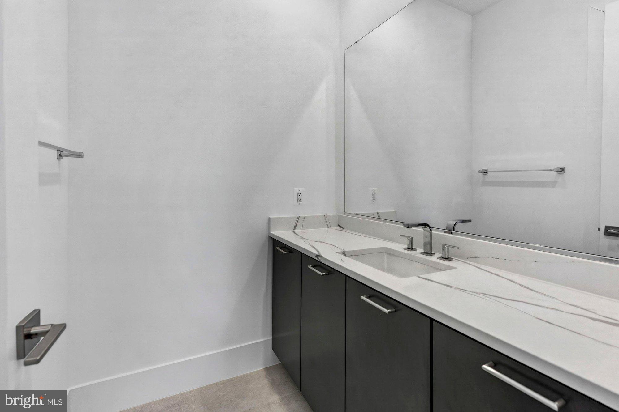 1221 Riley Preserve Court McLean, VA 22102 - Photo 75 of 94 a bathroom with a granite countertop sink and a mirror