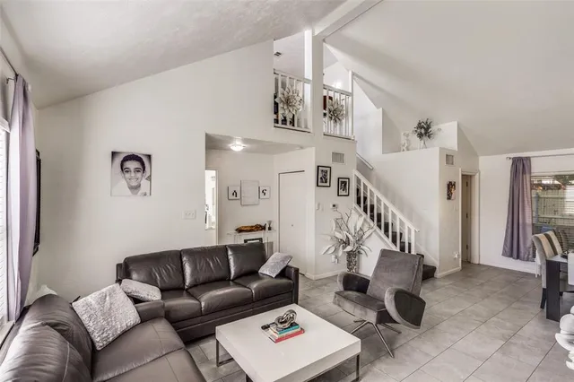 a living room with furniture and stairs