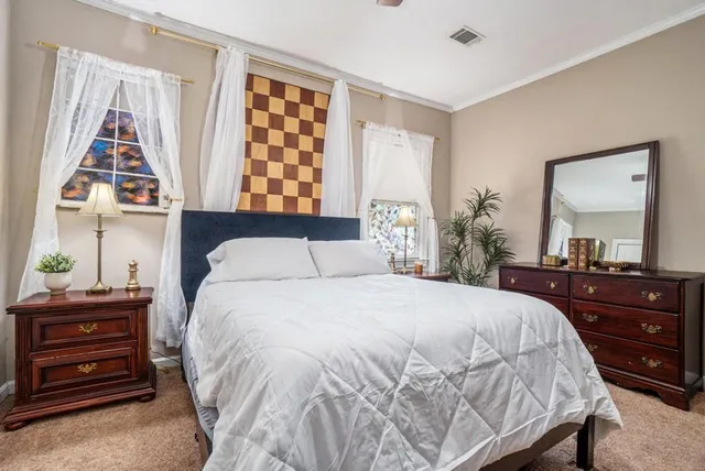 a bedroom with a bed and a dresser