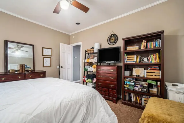 a bedroom with furniture and a flat screen tv