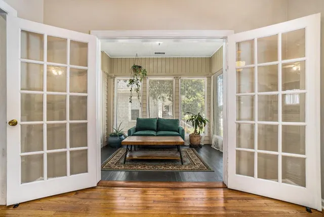 a living room with furniture windows and wooden floor