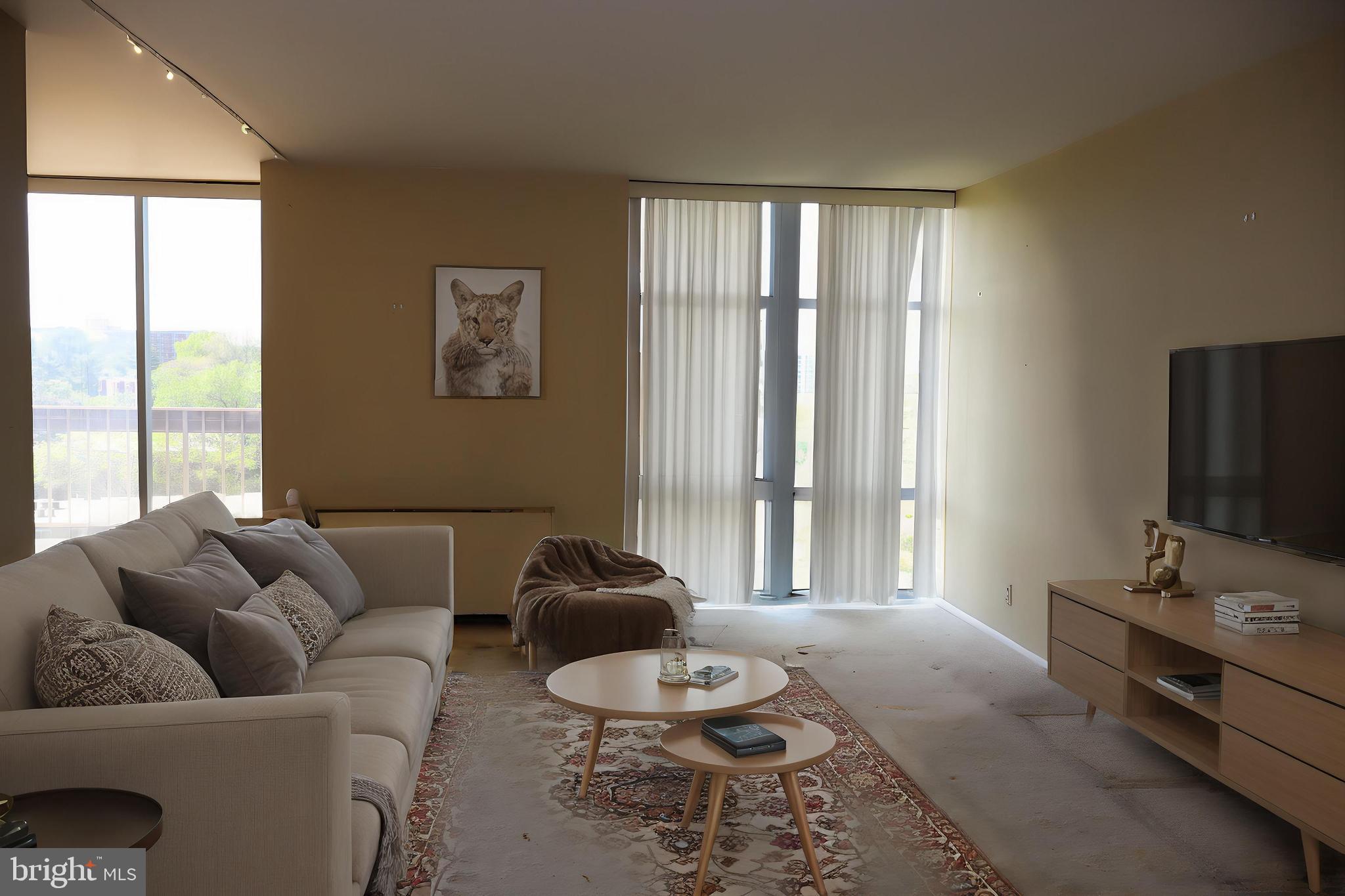 3600 Conshohocken Avenue, Unit 1004 Philadelphia, PA 19131 - Photo 9 of 17 a living room with furniture and a flat screen tv