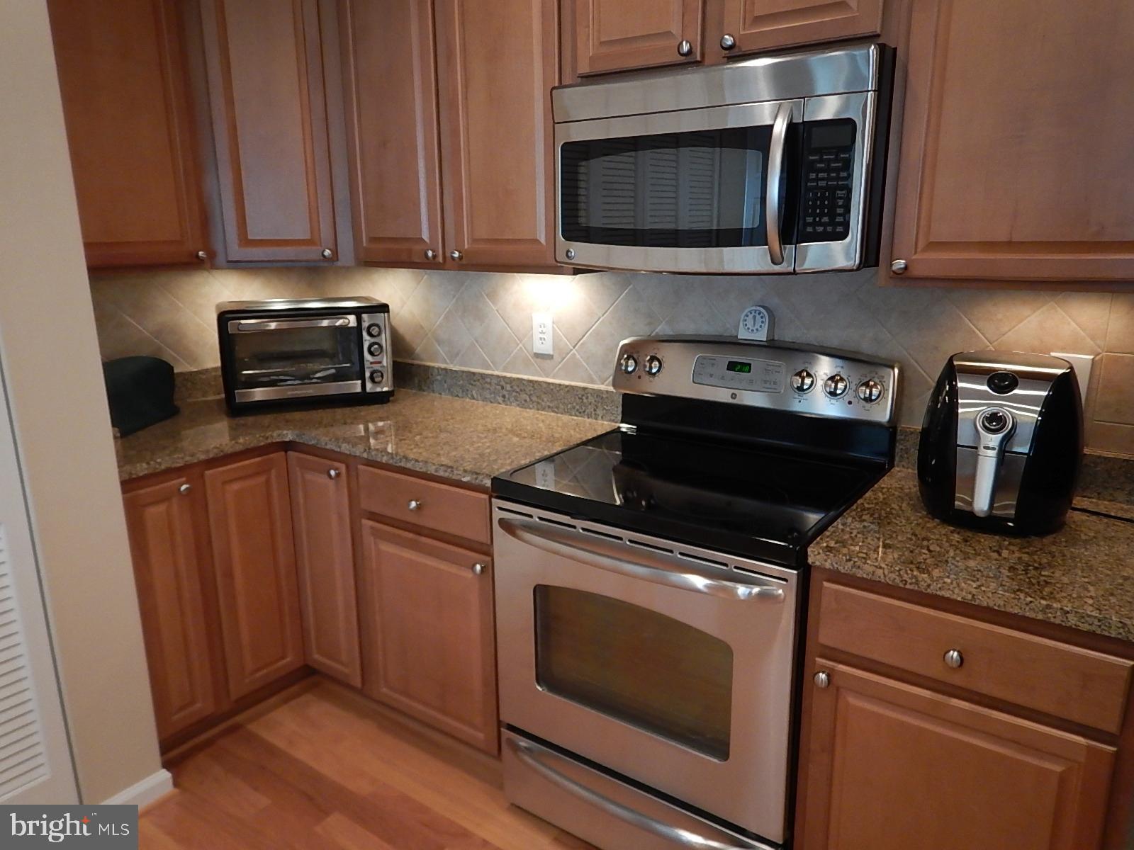 633 Wallingford Road, Unit 201 Bel Air, MD 21014 - Photo 11 of 38 a kitchen with granite countertop wood cabinets and stainless steel appliances