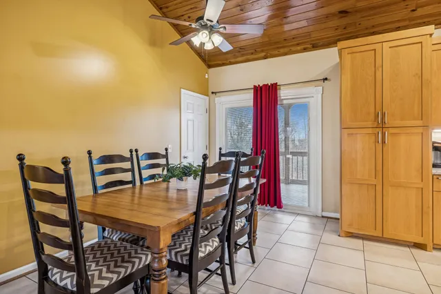 a spacious bathroom with a granite countertop sink a toilet a mirror and bathtub