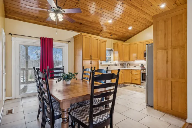 a spacious bathroom with a granite countertop sink toilet mirror and shower
