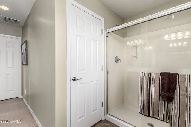 a bathroom with a glass shower door and a sink