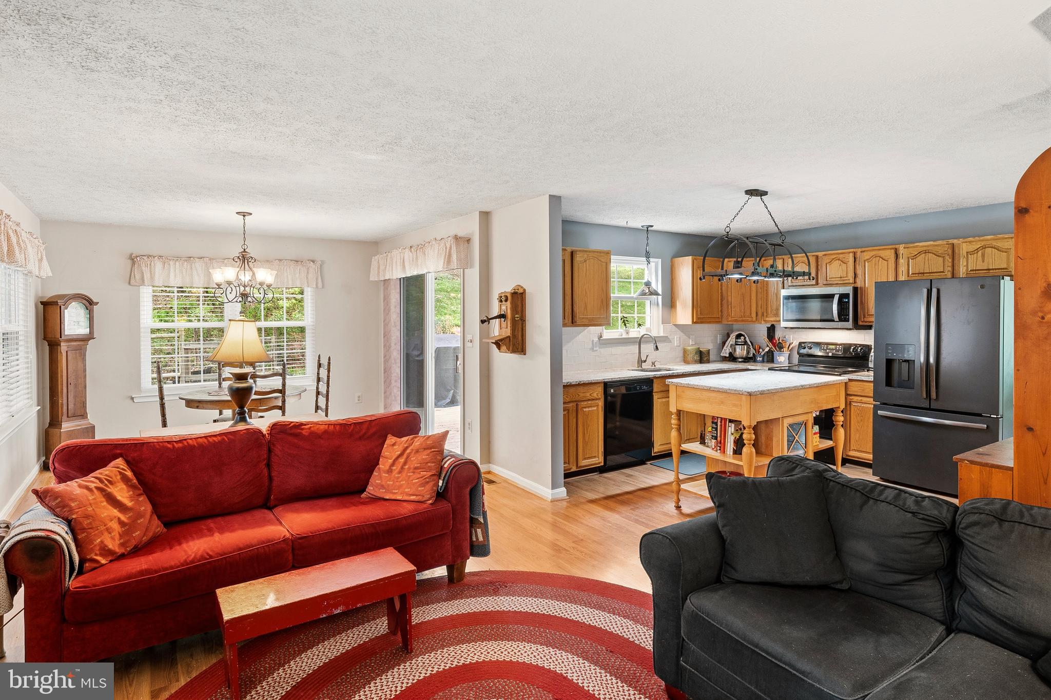 6415 Michael Elizabeth Way Hanover, MD 21076 - Photo 12 of 32 a living room with a couch and a dining table