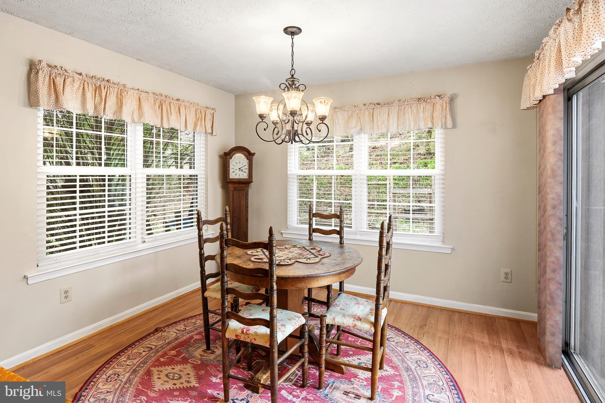 6415 Michael Elizabeth Way Hanover, MD 21076 - Photo 17 of 32 a dining room with chandelier fan and wooden floor