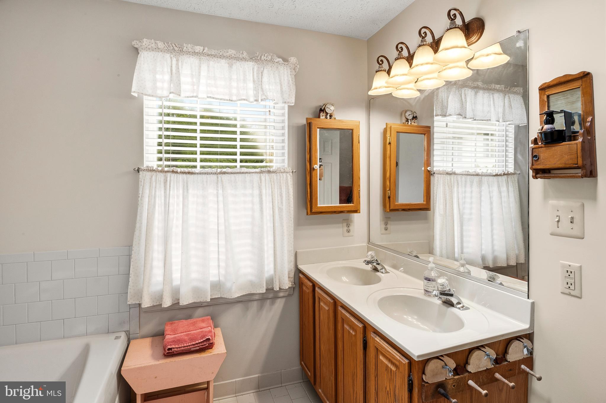 6415 Michael Elizabeth Way Hanover, MD 21076 - Photo 22 of 32 a bathroom with a sink double vanity and a mirror