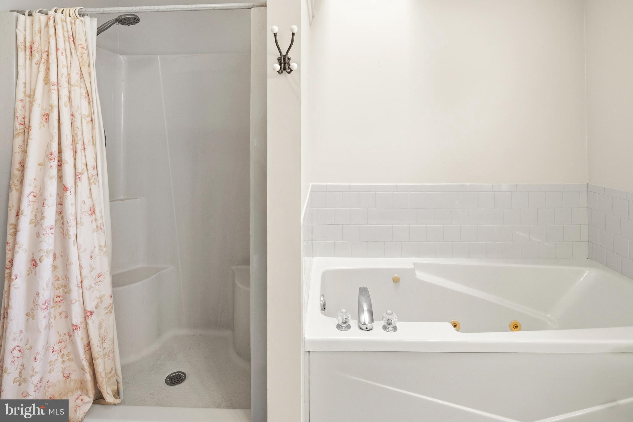 6415 Michael Elizabeth Way Hanover, MD 21076 - Photo 23 of 32 a bathroom with a bathtub and a shower