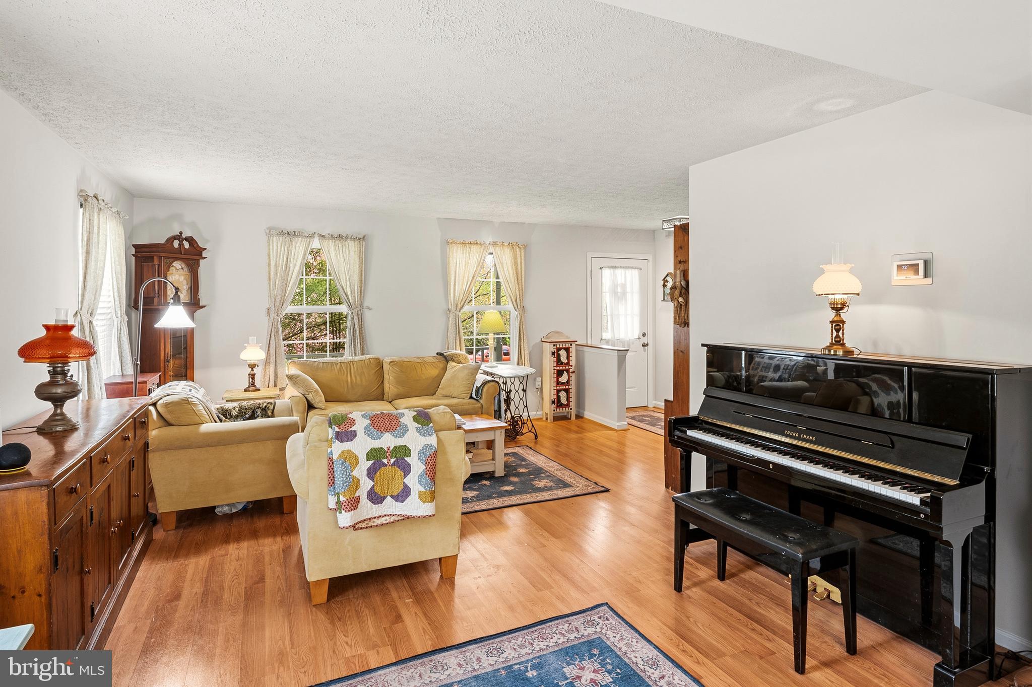 6415 Michael Elizabeth Way Hanover, MD 21076 - Photo 7 of 32 a living room with furniture and a wooden floor