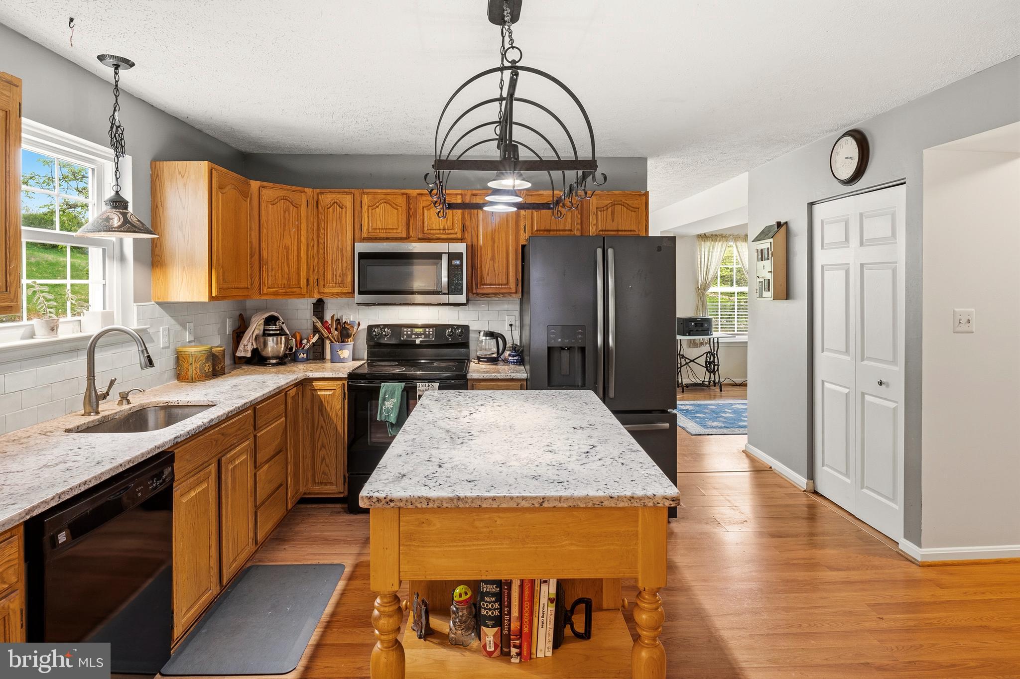 6415 Michael Elizabeth Way Hanover, MD 21076 - Photo 10 of 32 a kitchen with stainless steel appliances granite countertop a sink stove and refrigerator