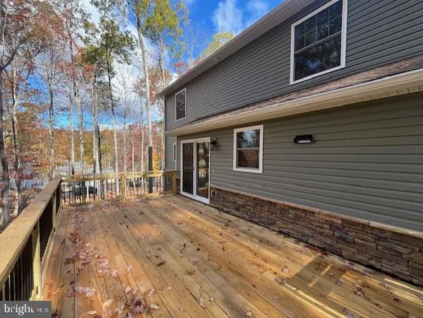 a large kitchen with stainless steel appliances kitchen island a large counter top and a wooden floors