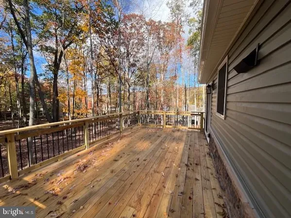 a kitchen with stainless steel appliances granite countertop a refrigerator a stove a sink dishwasher a kitchen island a dining table and chairs