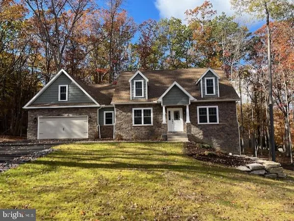 a front view of a house with yard and garage