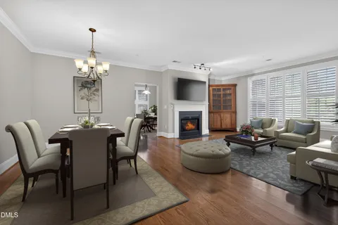 a living room with furniture a fireplace and a chandelier