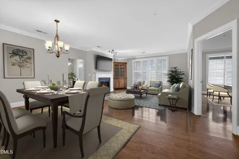a living room with fireplace furniture and a chandelier
