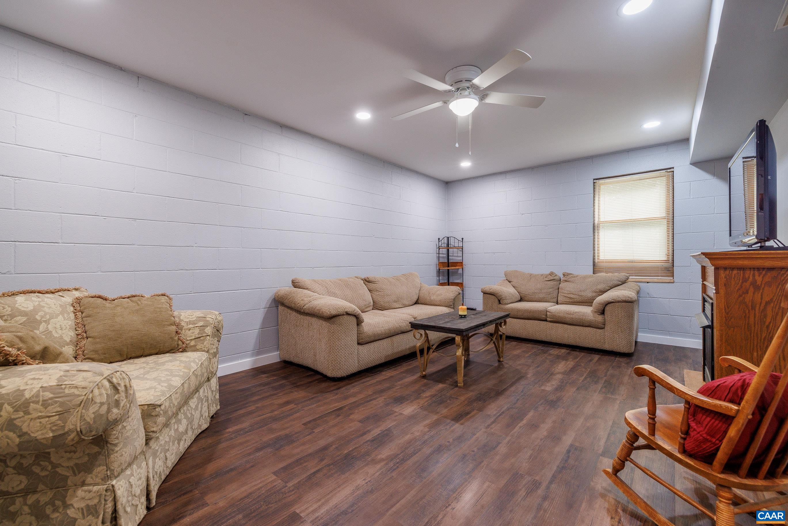 335 Morning Glory Road Ruckersville, VA 22968 - Photo 36 of 43 a living room with furniture and a flat screen tv