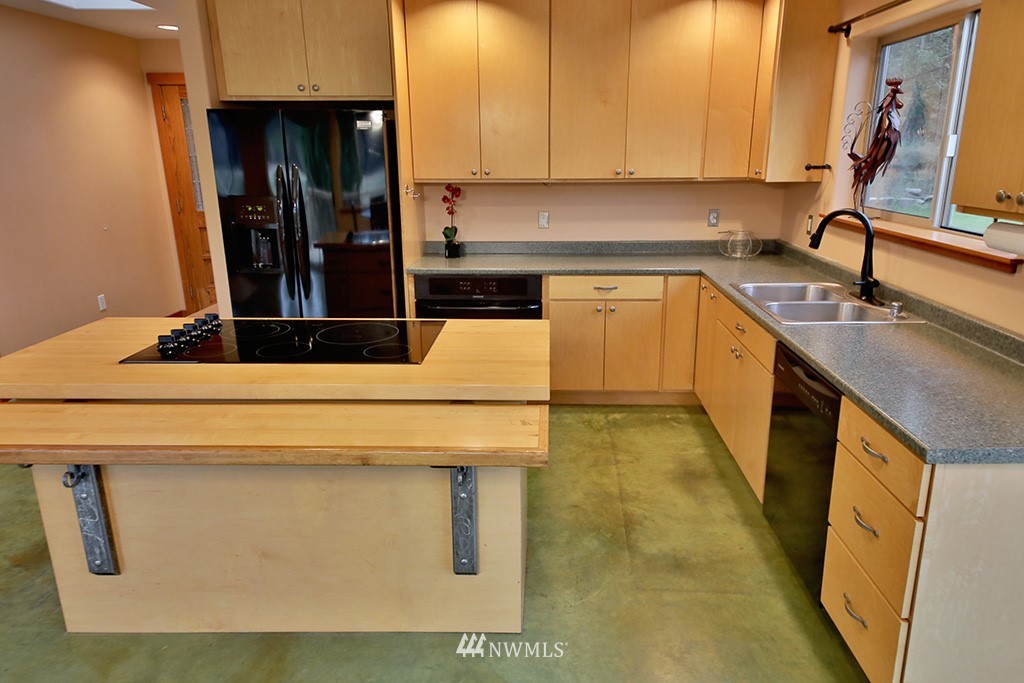 6301 Wahl Road Freeland, WA 98249 - Photo 12 of 40 a kitchen with a sink a stove and cabinets