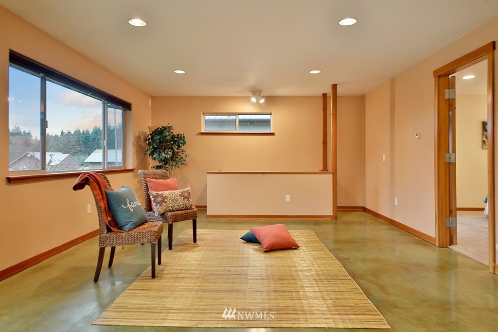 6301 Wahl Road Freeland, WA 98249 - Photo 15 of 40 a view of a dining room with furniture a rug and wooden floor