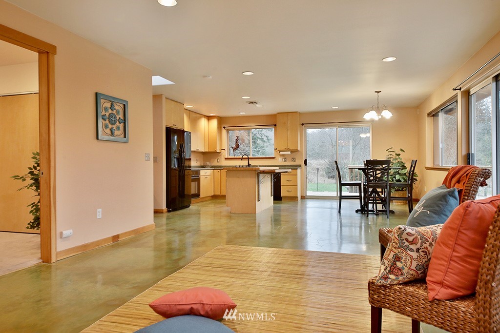 6301 Wahl Road Freeland, WA 98249 - Photo 17 of 40 a living room with stainless steel appliances furniture wooden floor and a kitchen view
