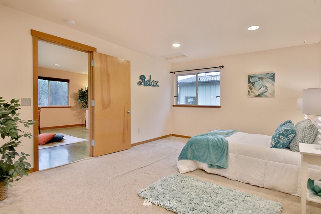 6301 Wahl Road Freeland, WA 98249 - Photo 18 of 40 a bedroom with furniture and a mirror