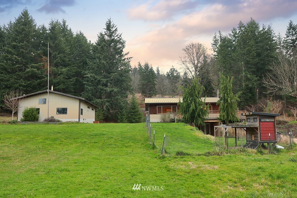 6301 Wahl Road Freeland, WA 98249 - Photo 29 of 40 a view of a house with a yard and sitting area