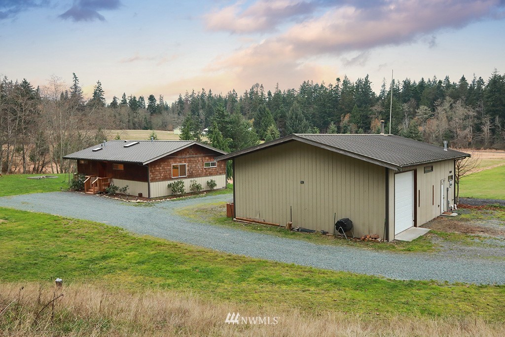6301 Wahl Road Freeland, WA 98249 - Photo 31 of 40 a view of a house with a yard