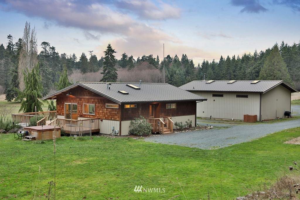 6301 Wahl Road Freeland, WA 98249 - Photo 39 of 40 a view of a house with a yard and sitting area