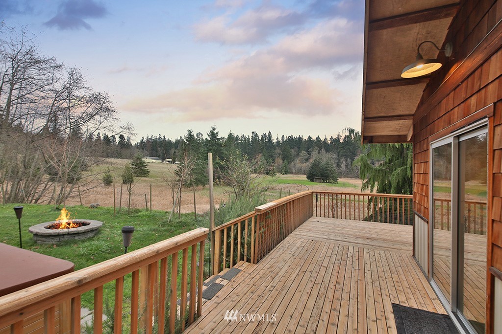 6301 Wahl Road Freeland, WA 98249 - Photo 5 of 40 a view of a wooden deck with a yard