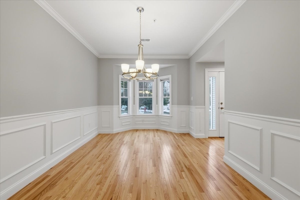 28 Eastover Road, Unit 28 Walpole, MA 02081 - Photo 12 of 34 a view of an empty room with wooden floor and a window
