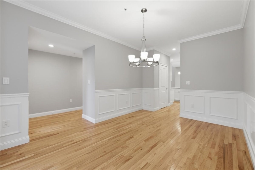 28 Eastover Road, Unit 28 Walpole, MA 02081 - Photo 13 of 34 a view of a livingroom with a chandelier wooden floor and chandelier