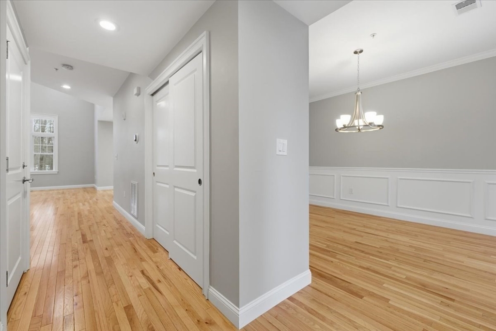 28 Eastover Road, Unit 28 Walpole, MA 02081 - Photo 14 of 34 a view of empty room with wooden floor and fan