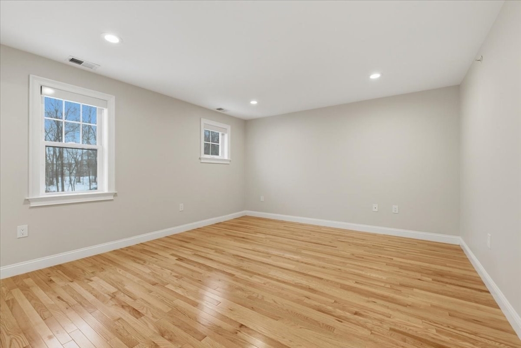 28 Eastover Road, Unit 28 Walpole, MA 02081 - Photo 17 of 34 a view of empty room with wooden floor and fan