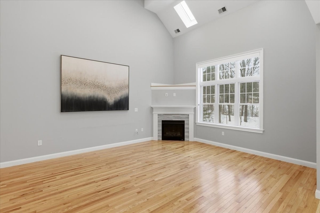 28 Eastover Road, Unit 28 Walpole, MA 02081 - Photo 2 of 34 a view of an empty room with wooden floor and a window