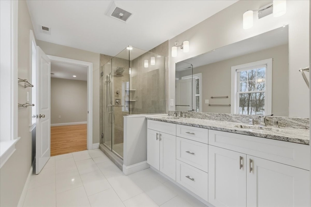 28 Eastover Road, Unit 28 Walpole, MA 02081 - Photo 21 of 34 a bathroom with a granite countertop sink mirror and double