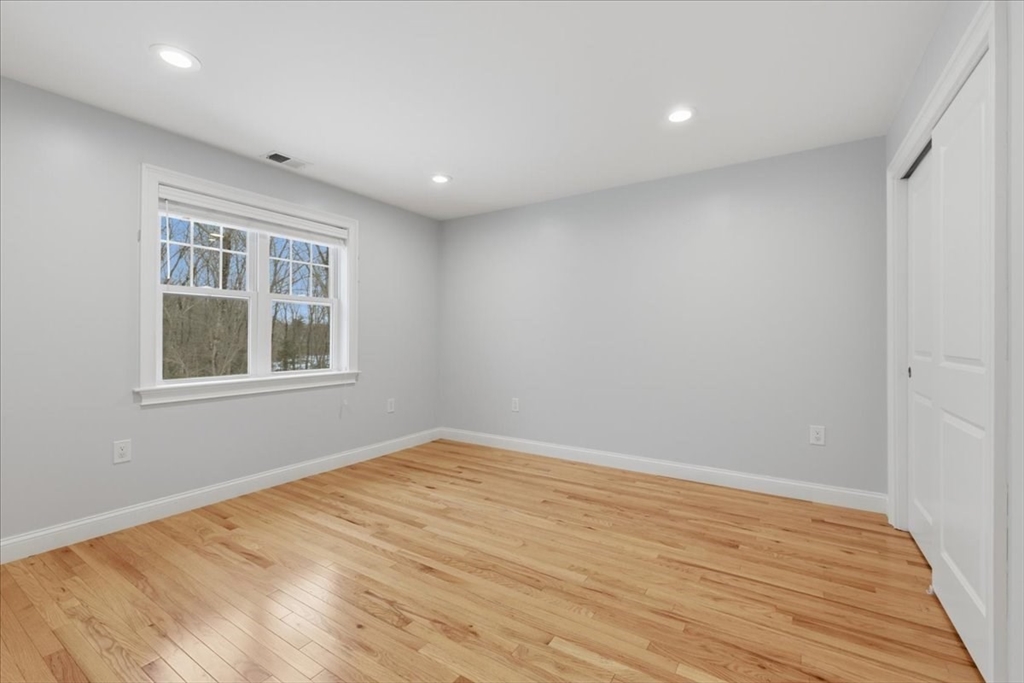 28 Eastover Road, Unit 28 Walpole, MA 02081 - Photo 23 of 34 a view of empty room with wooden floor and fan
