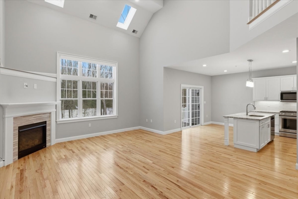 28 Eastover Road, Unit 28 Walpole, MA 02081 - Photo 4 of 34 a view of an empty room with window and wooden floor