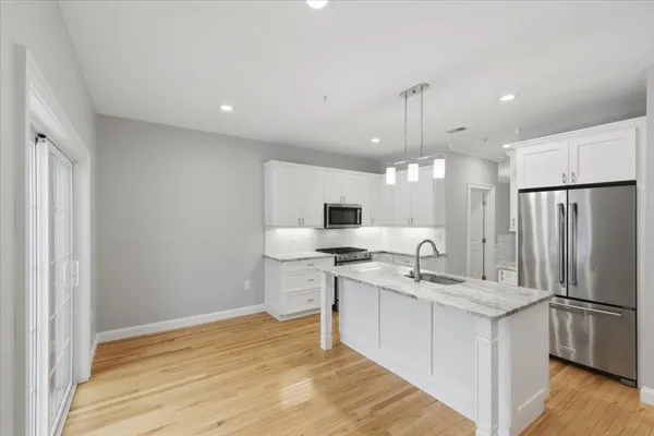 a kitchen with a sink appliances and cabinets