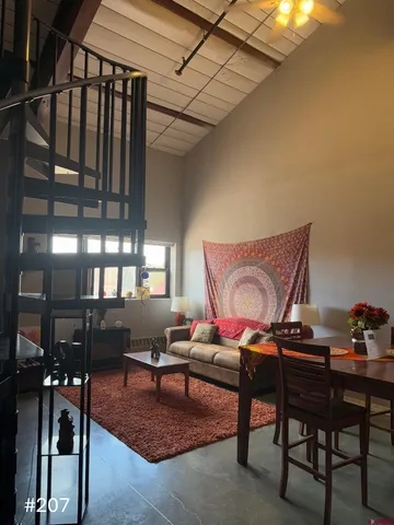 a living room with furniture a rug and a table