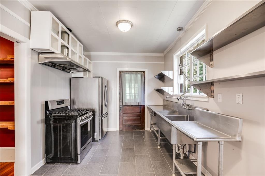427 East College Street Bowdon, GA 30108 - Photo 15 of 30 a kitchen with stainless steel appliances granite countertop a stove and a refrigerator