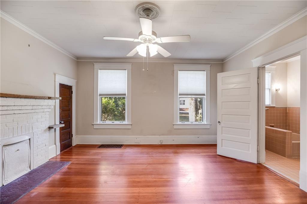 427 East College Street Bowdon, GA 30108 - Photo 19 of 30 an empty room with wooden floor chandelier and windows