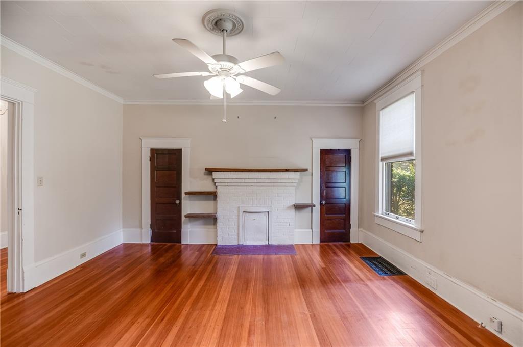 427 East College Street Bowdon, GA 30108 - Photo 20 of 30 a view of empty room with wooden floor and fan